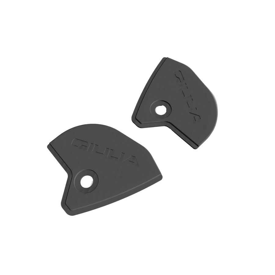 Pair of black 3D-printed Alfa Romeo Giulia fender liner cover caps with embossed Giulia logo and mounting screw hole, studio shot